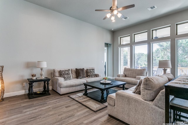 living room featuring ceiling fan and hardwood / wood-style floors