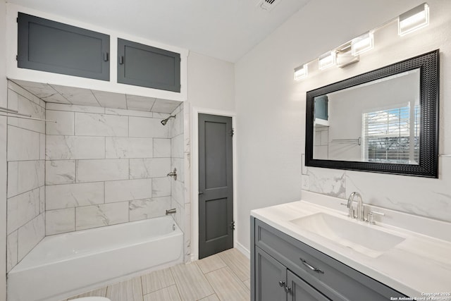 bathroom featuring vanity and tiled shower / bath