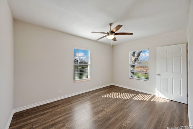 unfurnished room featuring dark hardwood / wood-style flooring and ceiling fan