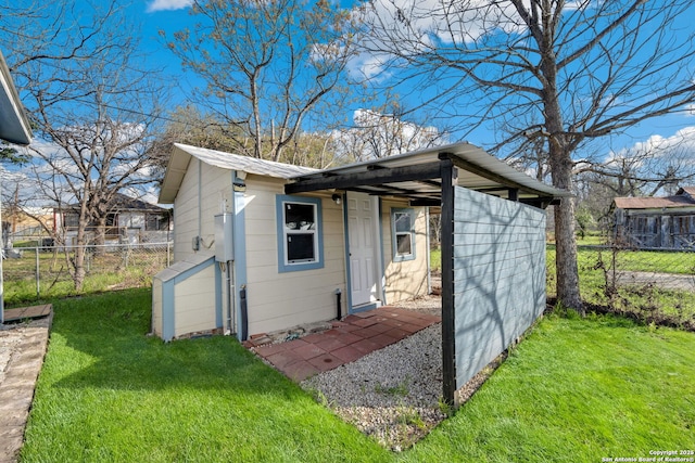 view of outbuilding featuring a lawn