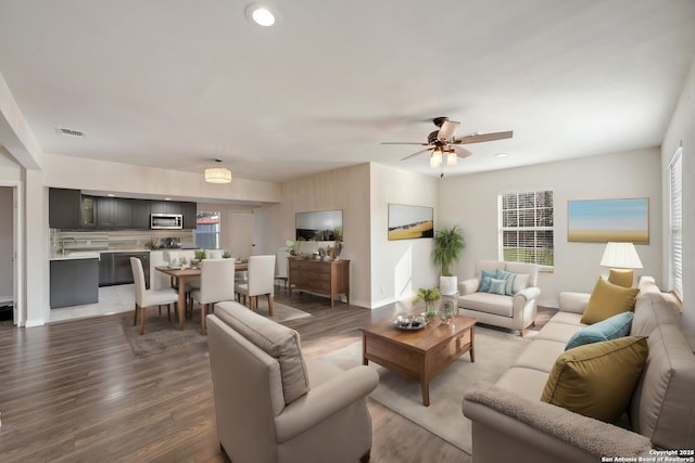 living room with hardwood / wood-style floors, ceiling fan, and a wealth of natural light