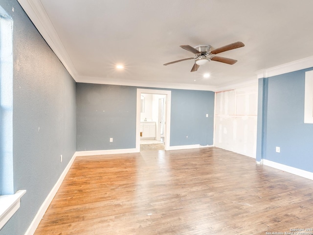 unfurnished room featuring ceiling fan, light wood-type flooring, and ornamental molding