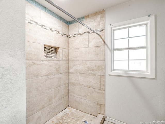 bathroom featuring tiled shower