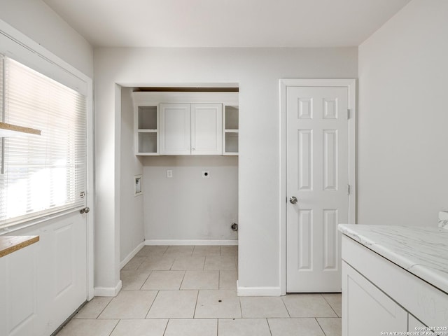 laundry room with hookup for an electric dryer, light tile patterned flooring, cabinets, and hookup for a washing machine