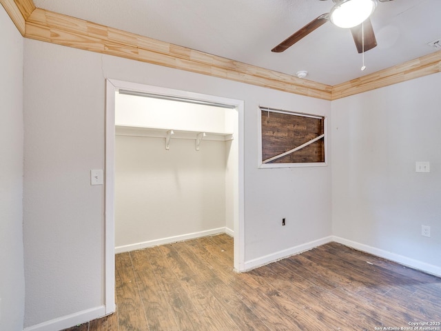 unfurnished bedroom featuring ceiling fan, a closet, and dark wood-type flooring