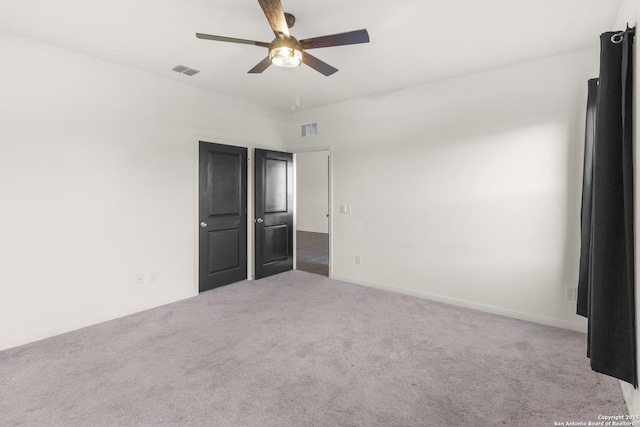 unfurnished bedroom with light carpet and ceiling fan