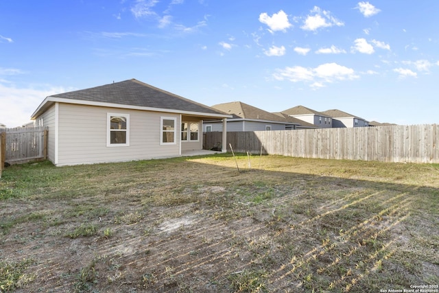 back of house with a yard