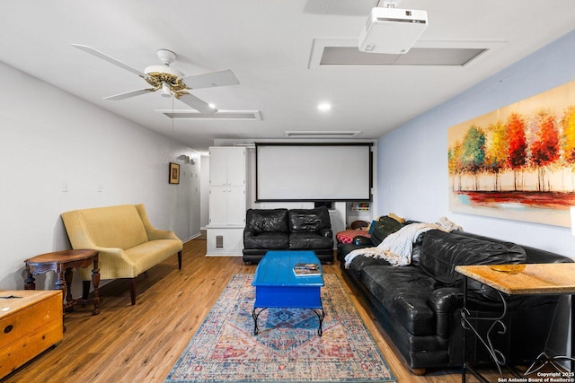 cinema with hardwood / wood-style floors and ceiling fan