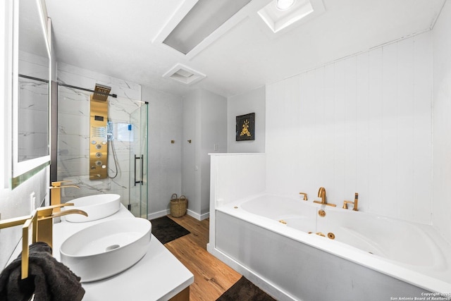 bathroom featuring hardwood / wood-style floors, vanity, and separate shower and tub