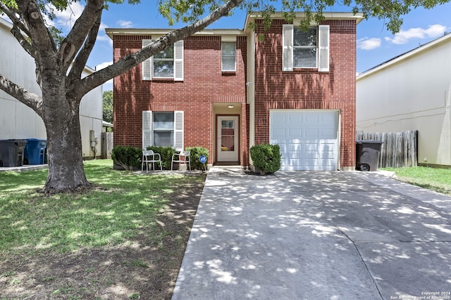 view of front of house with a garage and a front lawn