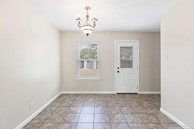 interior space with a notable chandelier and light tile patterned flooring