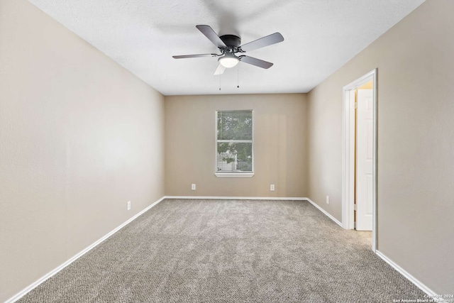 empty room featuring carpet flooring and ceiling fan