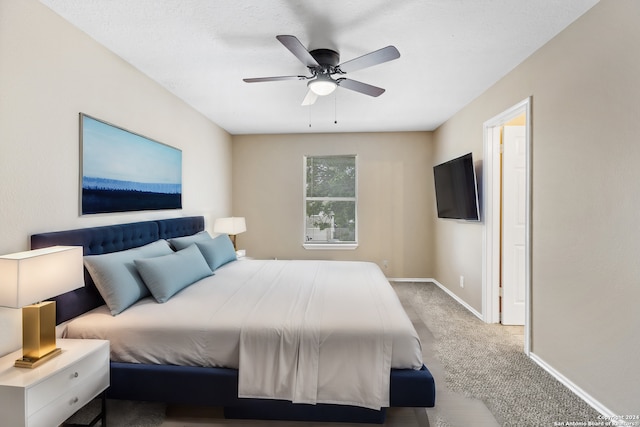 bedroom featuring light carpet and ceiling fan