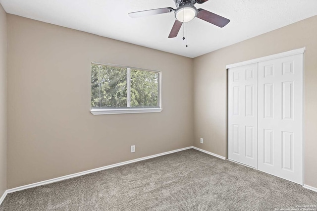 unfurnished bedroom with carpet, a closet, and ceiling fan