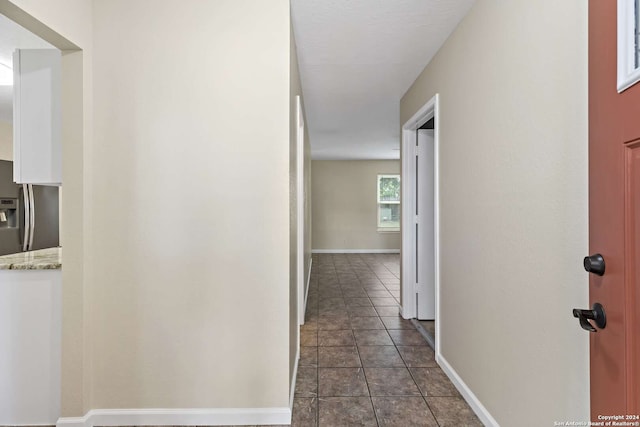 corridor with dark tile patterned flooring