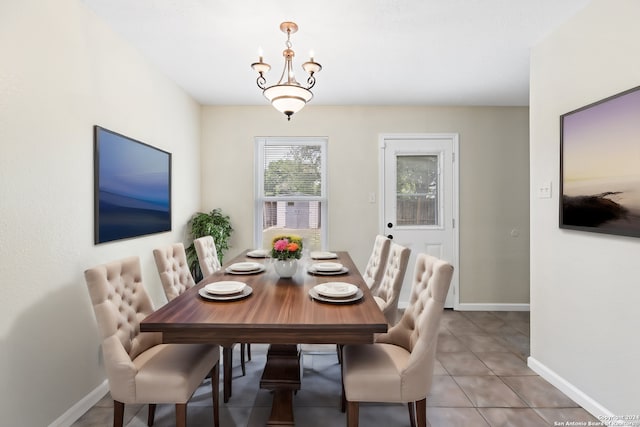 tiled dining space with a chandelier