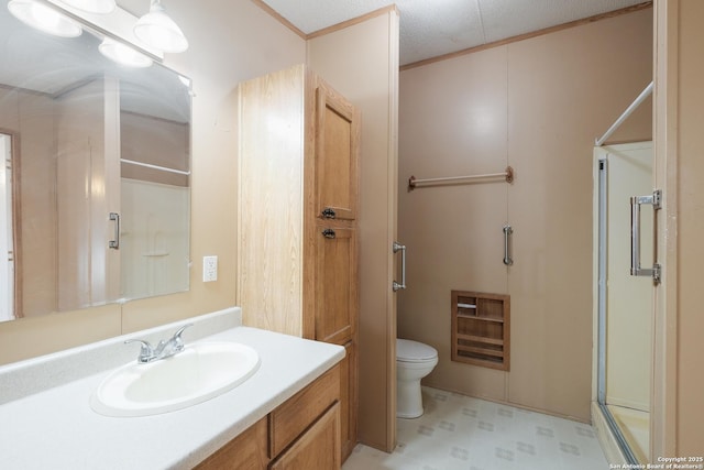 bathroom featuring vanity, a textured ceiling, toilet, and an enclosed shower