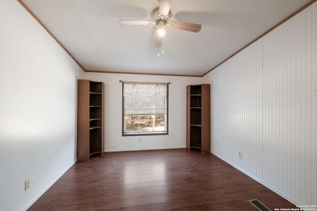 spare room with ceiling fan, dark hardwood / wood-style floors, and ornamental molding