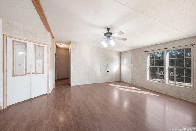 empty room with french doors, ceiling fan, and wood-type flooring