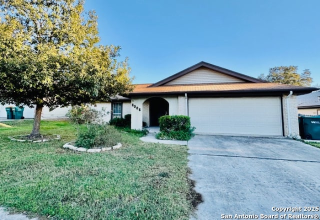 ranch-style home featuring a garage and a front yard