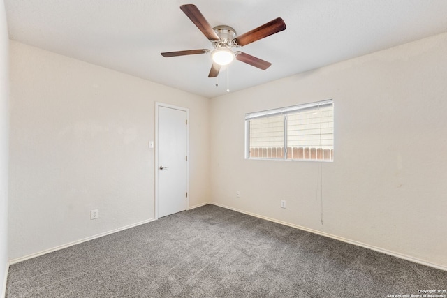 carpeted spare room featuring ceiling fan