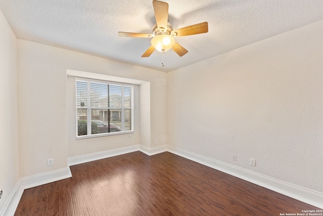 spare room with a textured ceiling, ceiling fan, and dark wood-type flooring