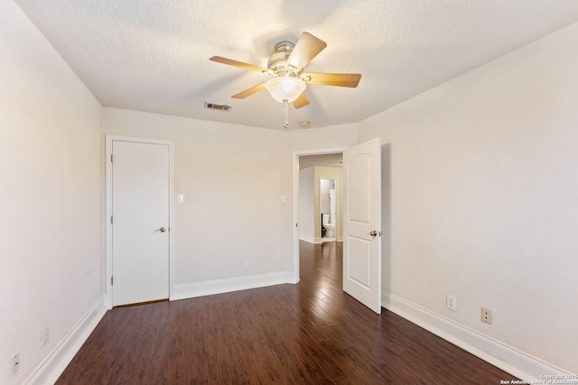 unfurnished room with a textured ceiling, ceiling fan, and dark wood-type flooring