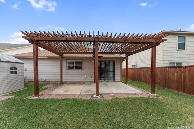 rear view of house featuring a yard, a pergola, and a patio