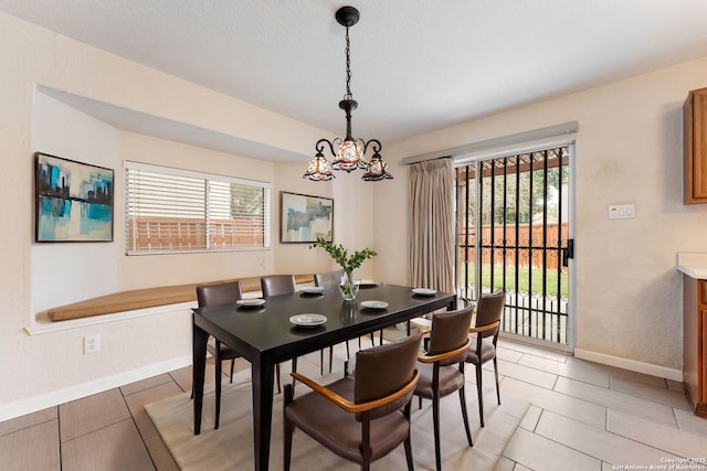 dining room featuring light tile patterned floors and an inviting chandelier