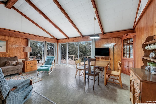 sunroom featuring lofted ceiling with beams