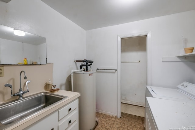 clothes washing area featuring sink, washer / clothes dryer, and water heater