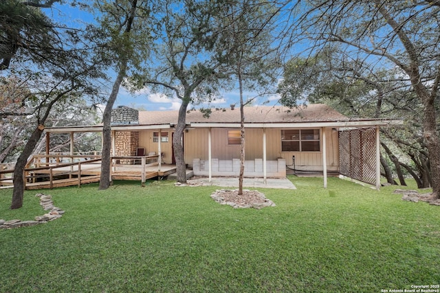 rear view of property with a yard