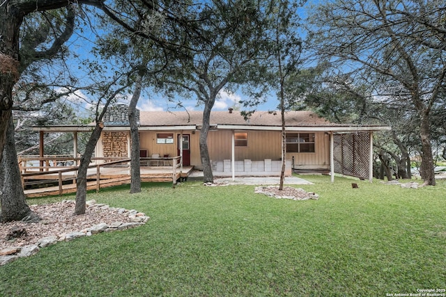 rear view of house featuring a patio area and a yard