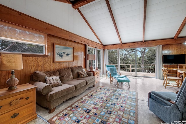 living room featuring wooden walls and lofted ceiling with beams