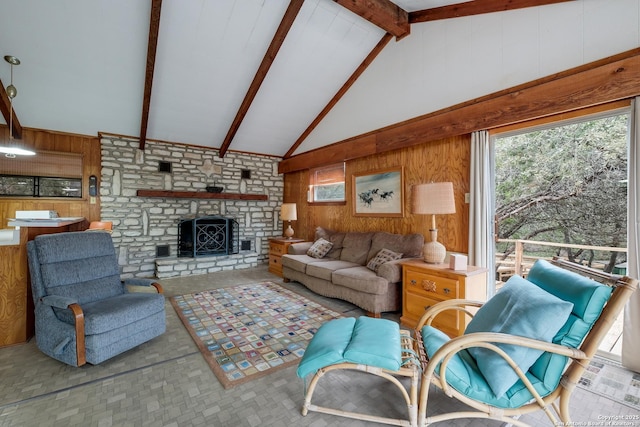 living room featuring lofted ceiling with beams, wood walls, and a fireplace