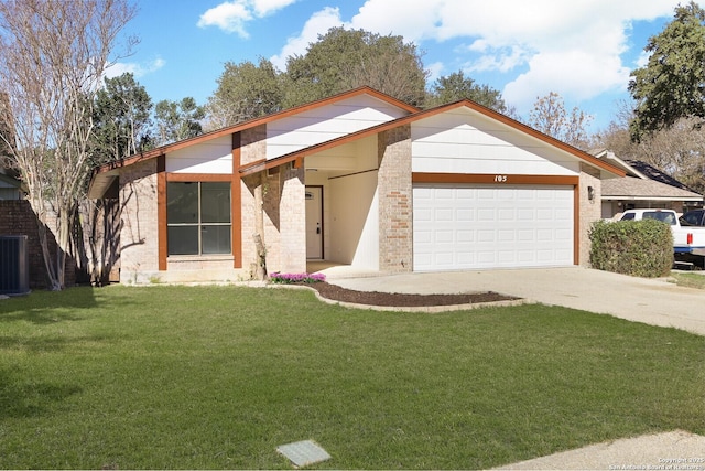 view of front facade featuring a front yard, a garage, and central AC unit