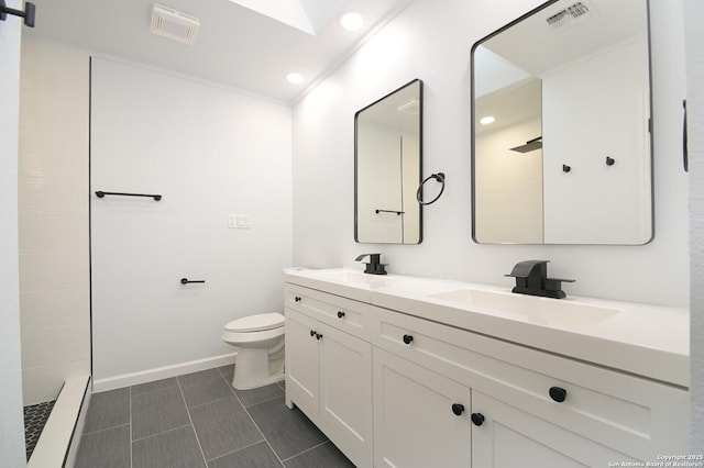 bathroom featuring tile patterned floors, vanity, toilet, and walk in shower