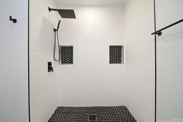 bathroom with tiled shower