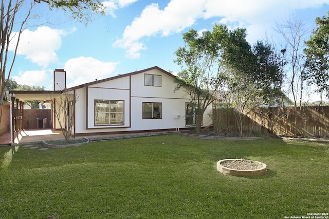 back of house featuring cooling unit and a yard