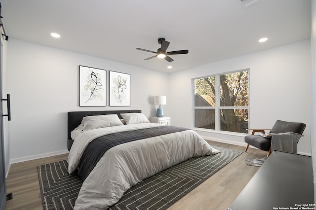 bedroom featuring hardwood / wood-style flooring and ceiling fan