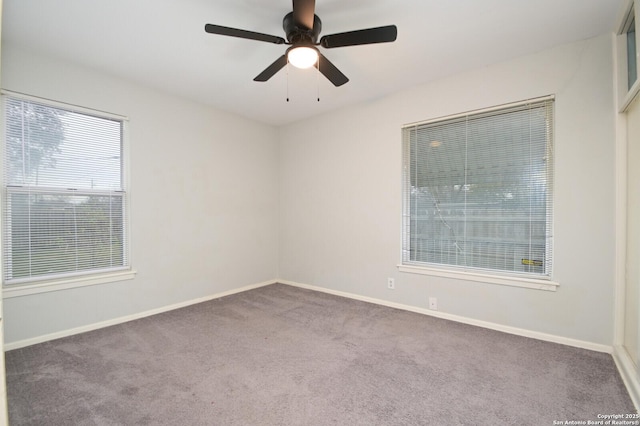 carpeted empty room featuring ceiling fan