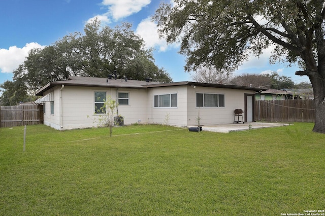 back of property with a patio and a lawn