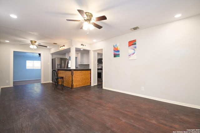 unfurnished living room with dark hardwood / wood-style flooring