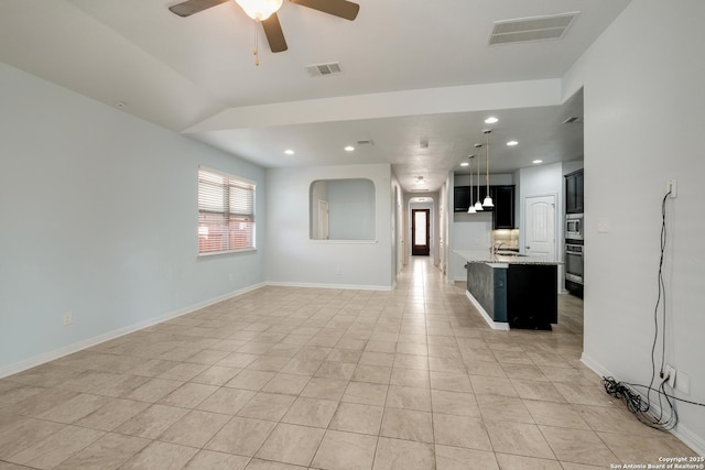 unfurnished living room with ceiling fan, light tile patterned flooring, and vaulted ceiling