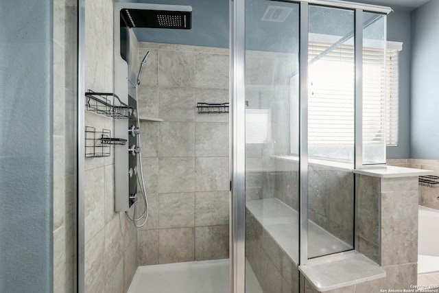 bathroom featuring shower with separate bathtub and a wealth of natural light