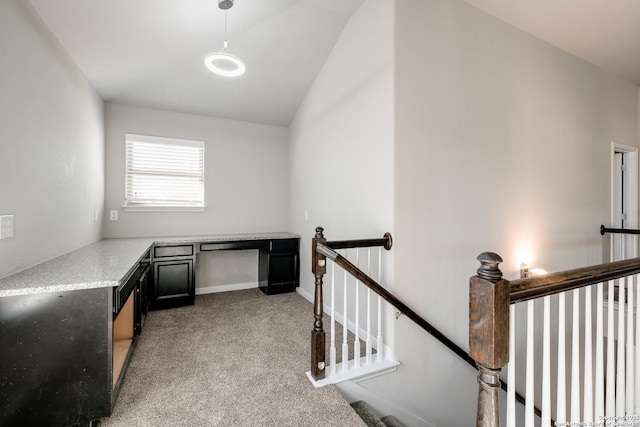 interior space featuring light colored carpet and vaulted ceiling