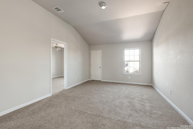 empty room featuring carpet flooring, ceiling fan, and lofted ceiling