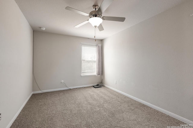 unfurnished room featuring ceiling fan and carpet