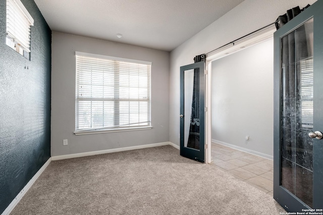 empty room with light carpet and french doors