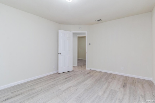 unfurnished room with light hardwood / wood-style flooring